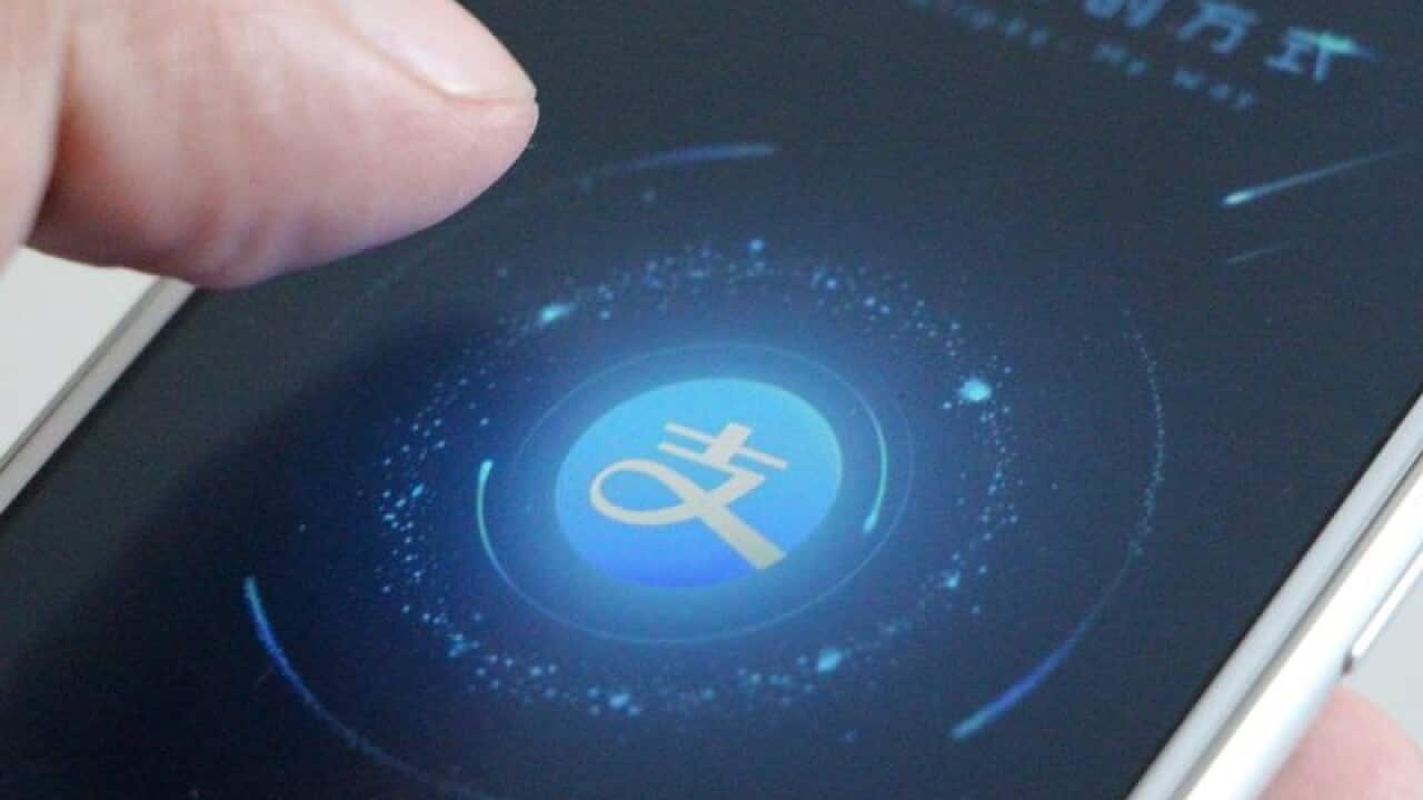 A file image of a mobile phone user using the Alipay app