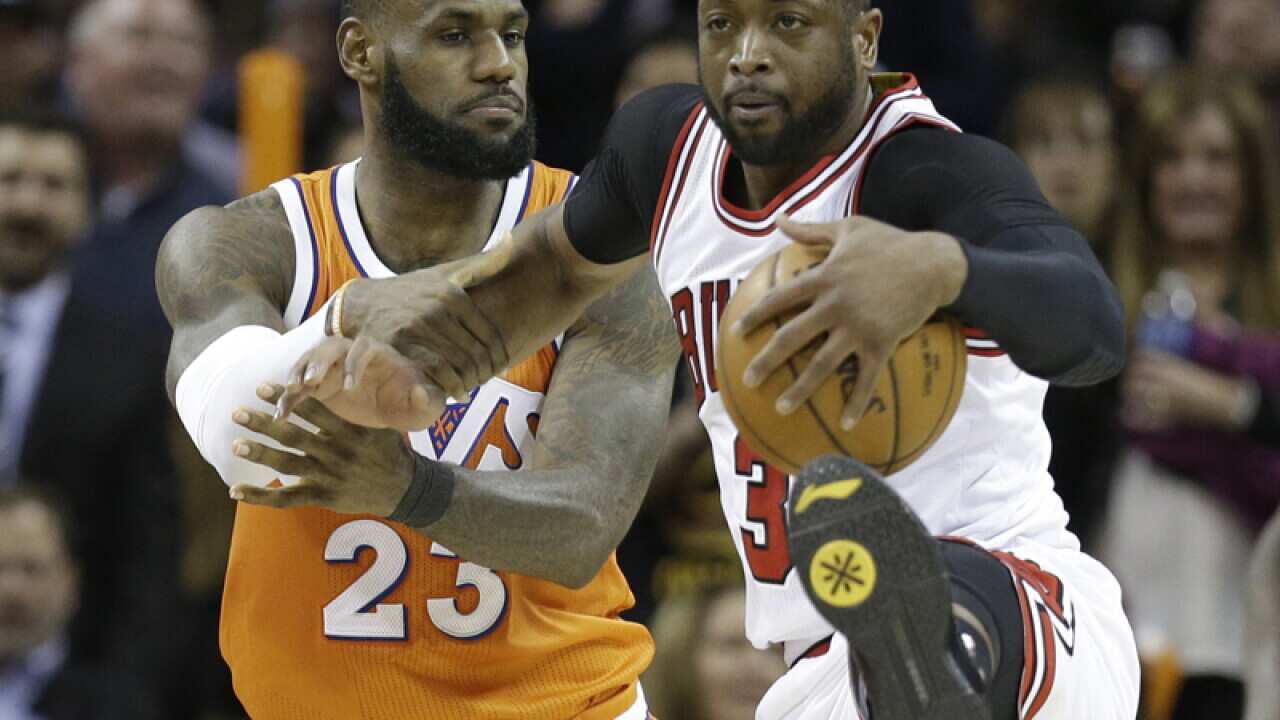Cavaliers' LeBron James (L) fouls Chicago's Dwyane Wade