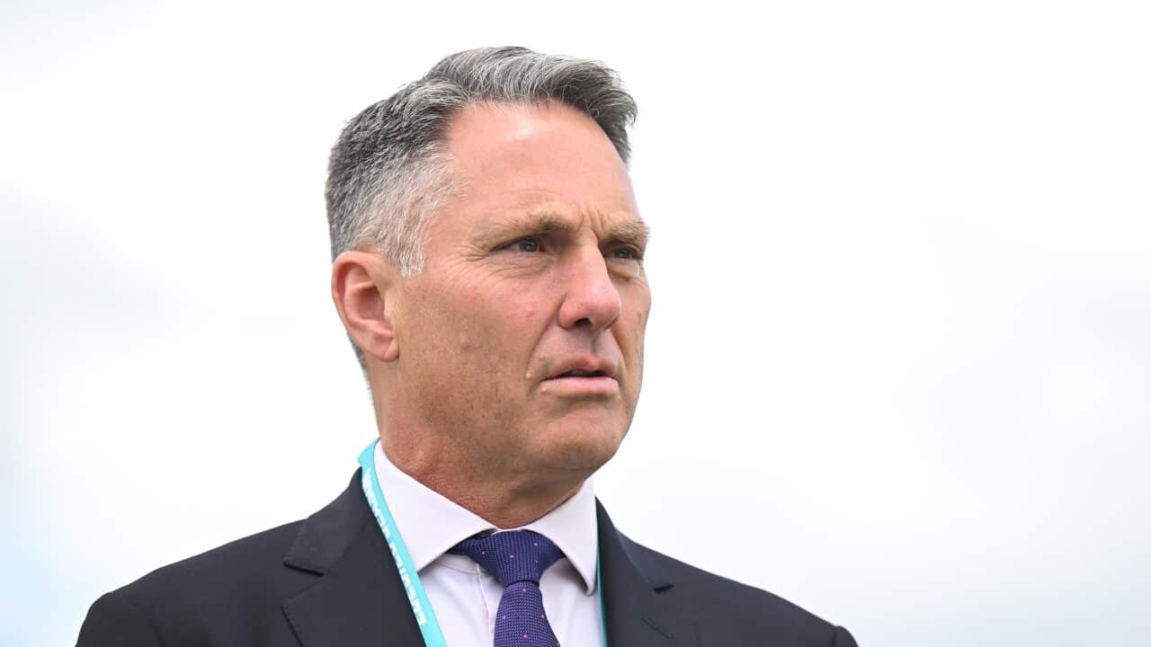 Richard Marles in a suit standing outside against a grey sky