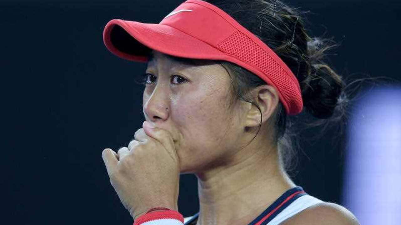 Shuai Zhang of China cries after winning her match against Simona Halep of Romania during their first round match on day two of the Australian Open.