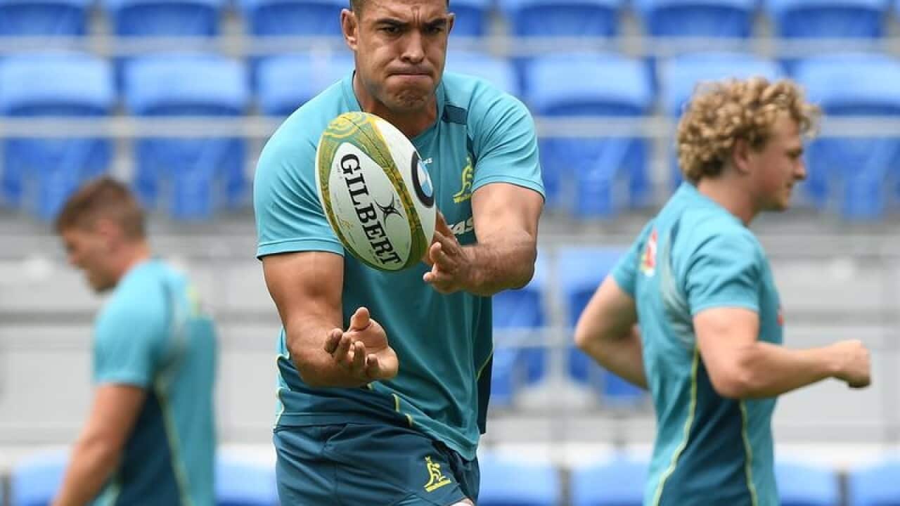 Wallabies player Rory Arnold passes the ball during a team training.