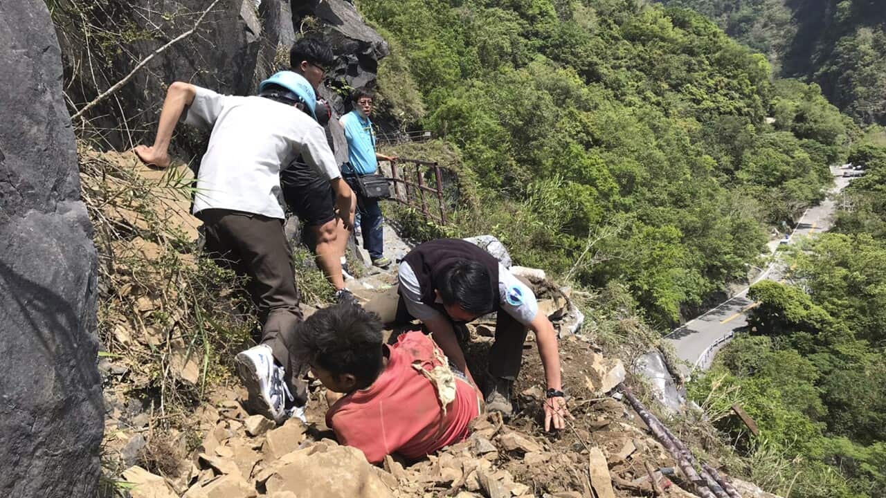 An injured Malaysian tourist is assisted by rescue workers at the Taroko National Park after a strong 6.1 magnitude earthquake struck Taiwan's east coast.