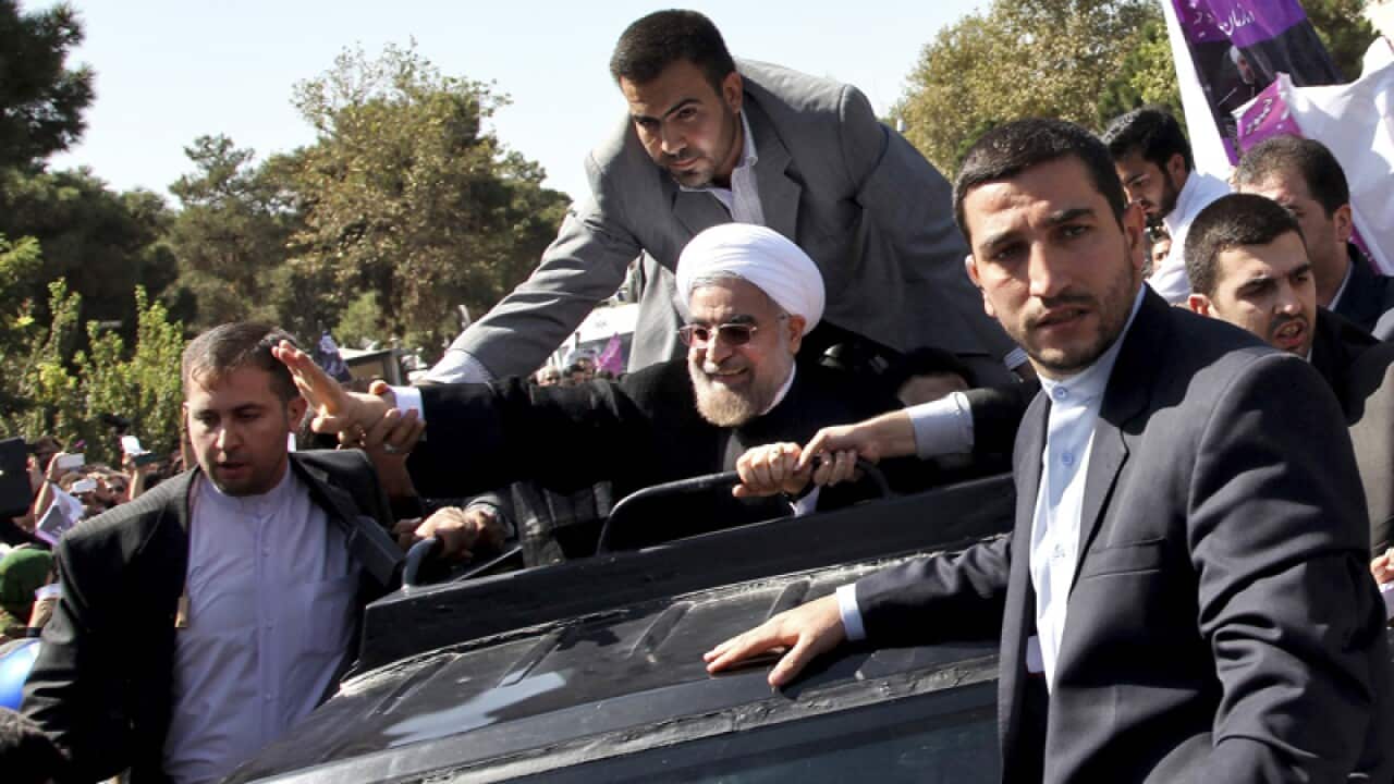 Iranian President Hassan Rouhani waves.