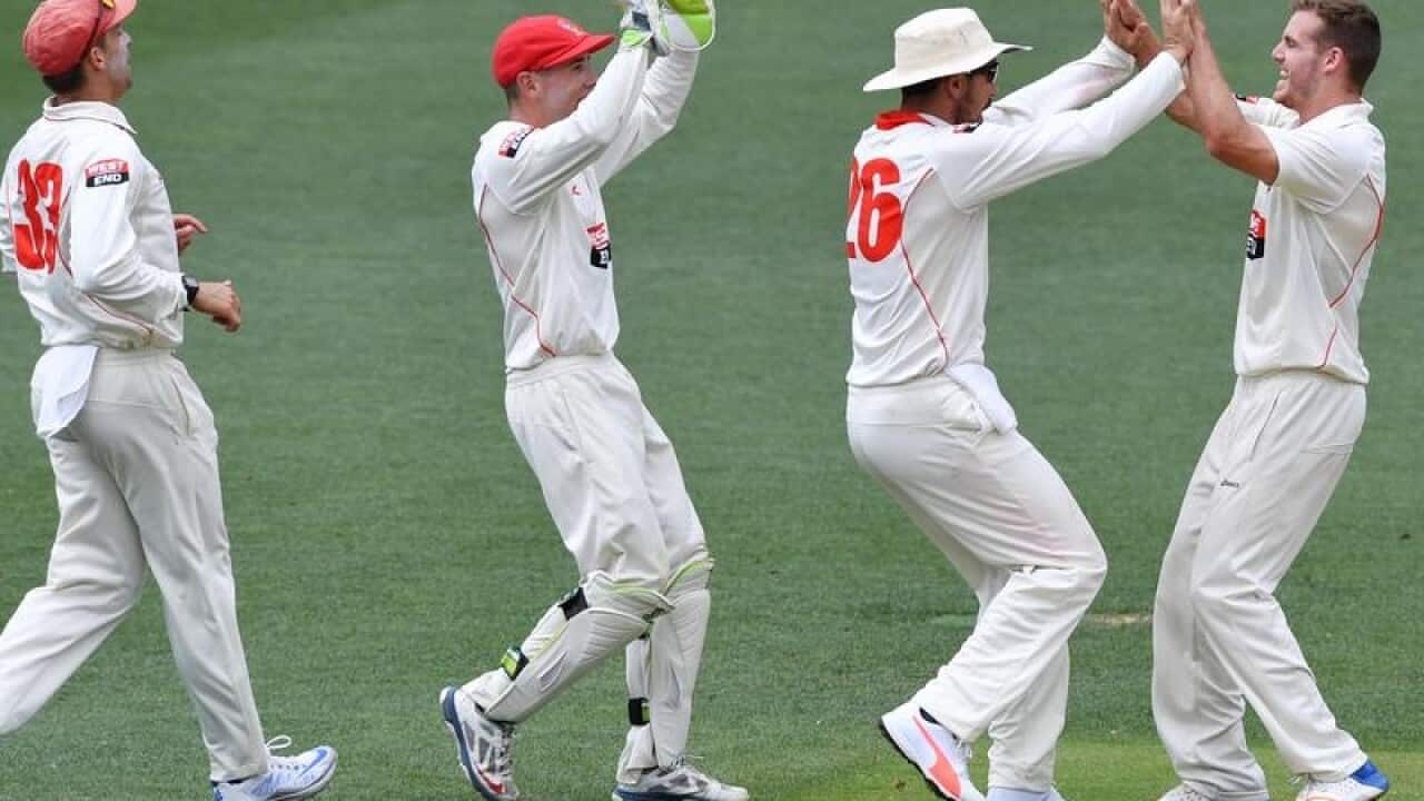 SA bowler Nick Winter (R) celebrates after claiming a wicket