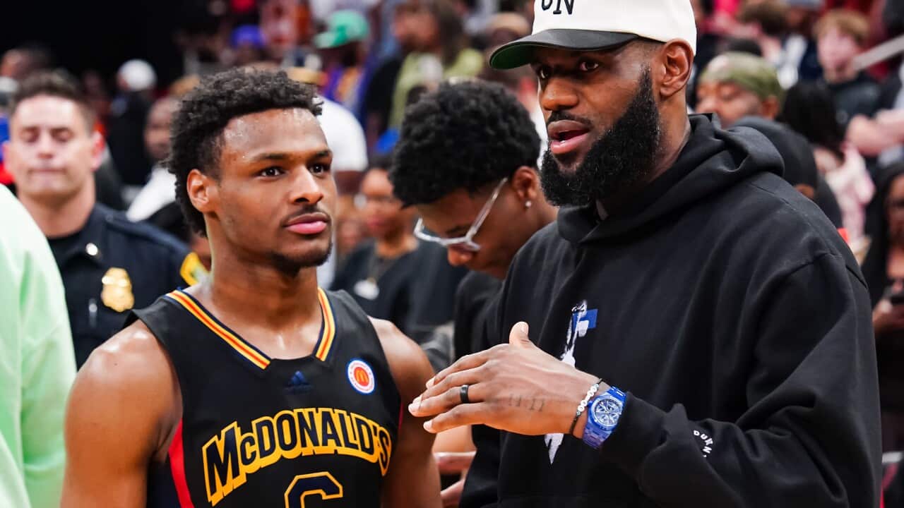 Bronny James talks to Lebron James.