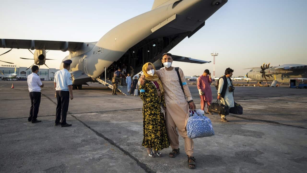 People evacuated from Afghanistan board a German Bundeswehr airplane on 17 August 2021.