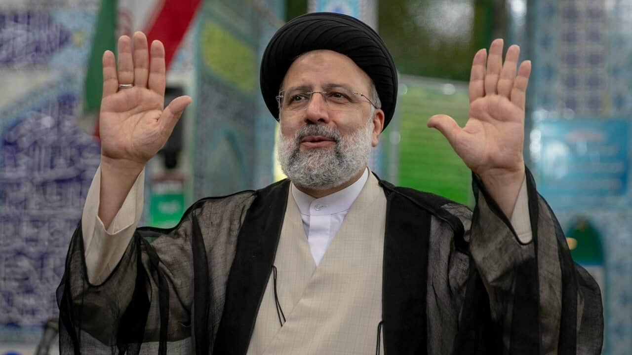 Ebrahim Raisi, a candidate in Iran's presidential elections, waves to the media after casting his vote at a polling station on 18 June, 2021.