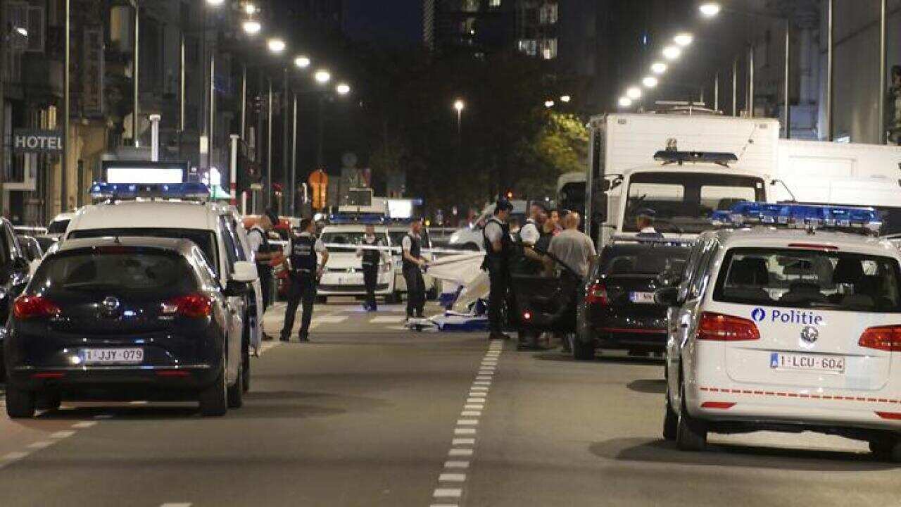 Police secure a scene in downtown Brussels after a reported attack on Belgian Army soldiers.