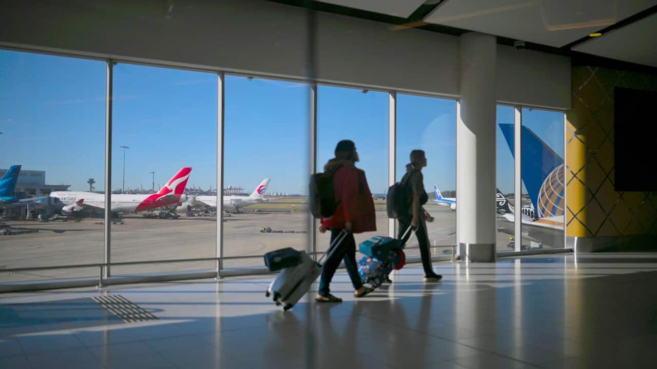 Passengers walk to their flights at Sydney International Airport in Sydney, Wednesday, August 21, 2019. (AAP Image/Lukas Coch) NO ARCHIVING