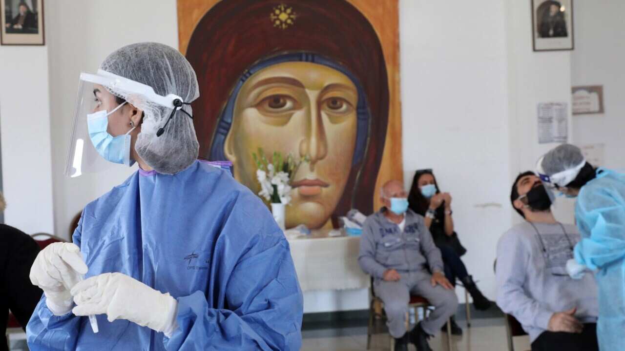 Cypriot health workers carry out coronavirus COVID-19 Rapid Antigen tests, in Nicosia, Cyprus.