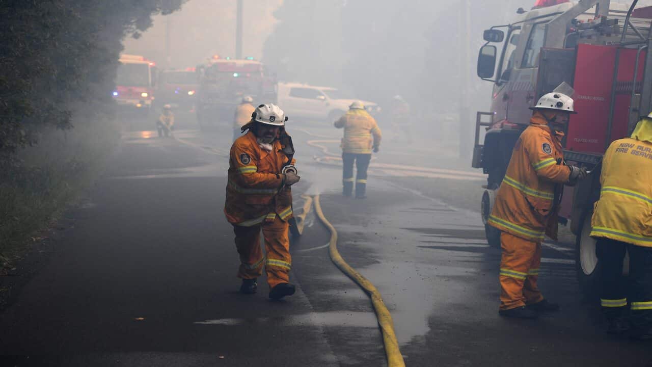 NSW Rural Fire Service personnel conduct property protection as a bushfire burns in Woodford NSW, Friday, November 8, 2019. Hot, windy conditions are wreaking havoc as bushfires burn out of control across parts of NSW, with 14 current emergency warnings i