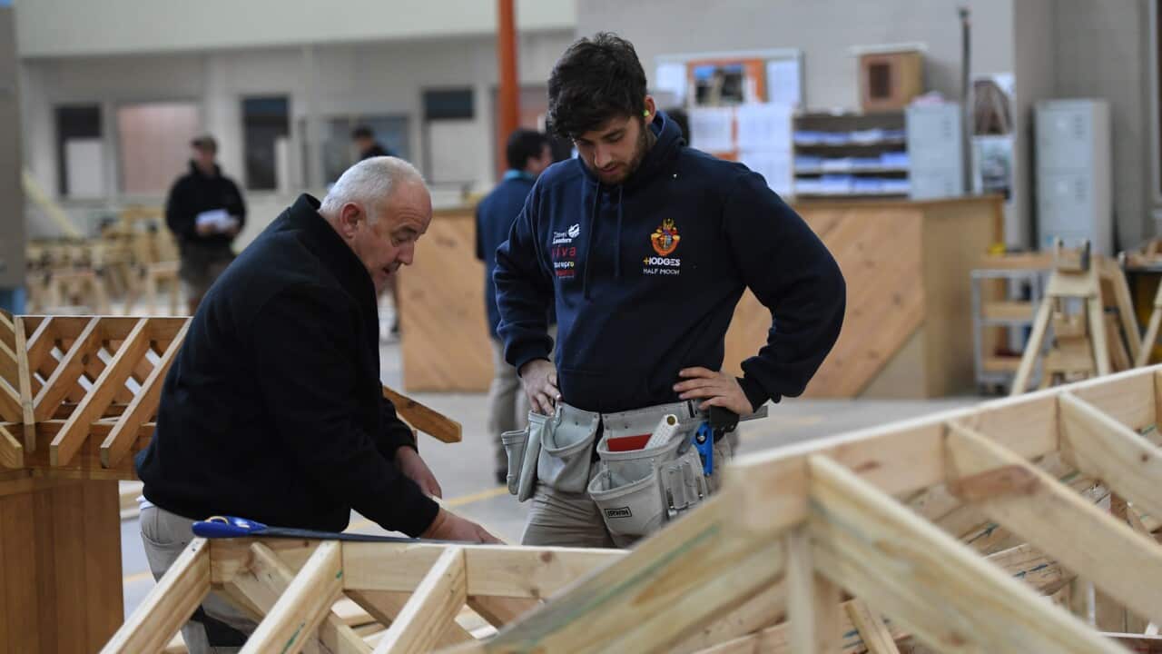 A master and apprentice carpenter are seen at Holmesglen TAFE Chadstone campus in Melbourne, Monday, May 15, 2017. (AAP Image/Julian Smith) NO ARCHIVING
