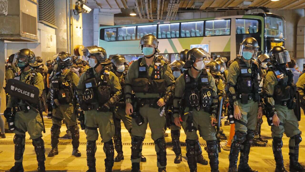 Riot police stand guard the Yuen Long subway station in Hong Kong, Tuesday, July 21, 2020.