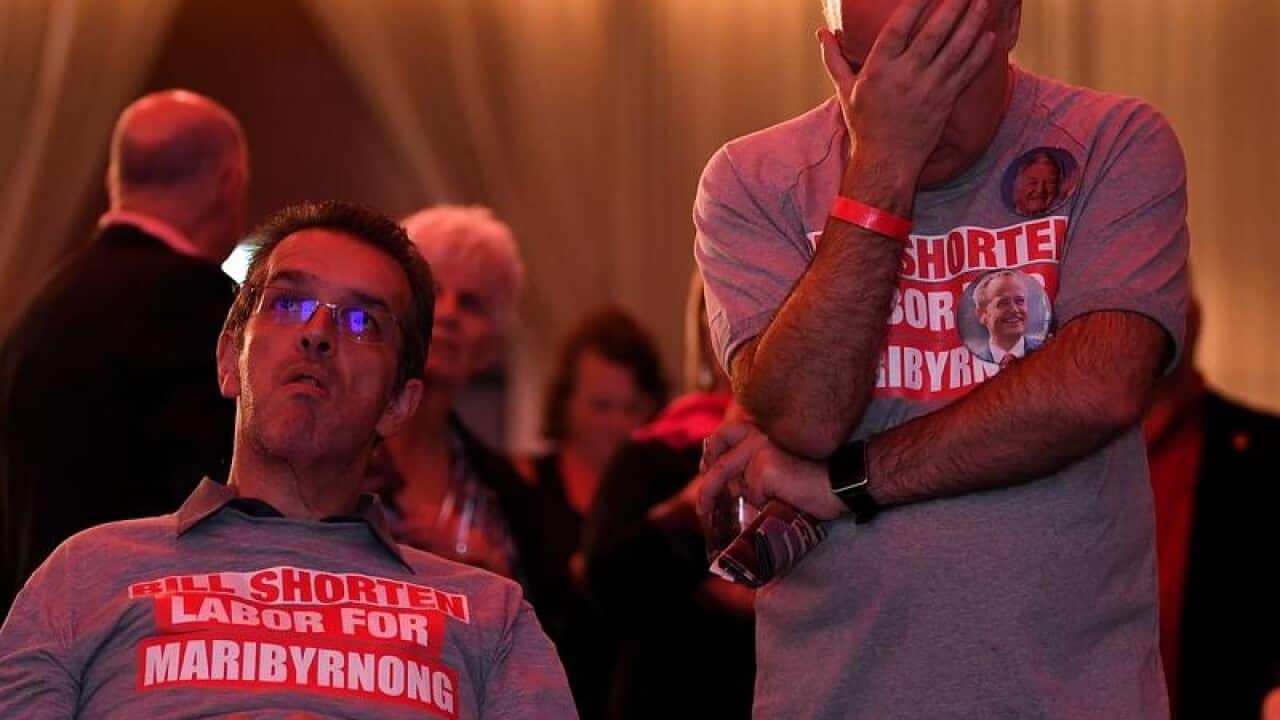 Labor supporters watch the tally count at the Federal Labor Reception.