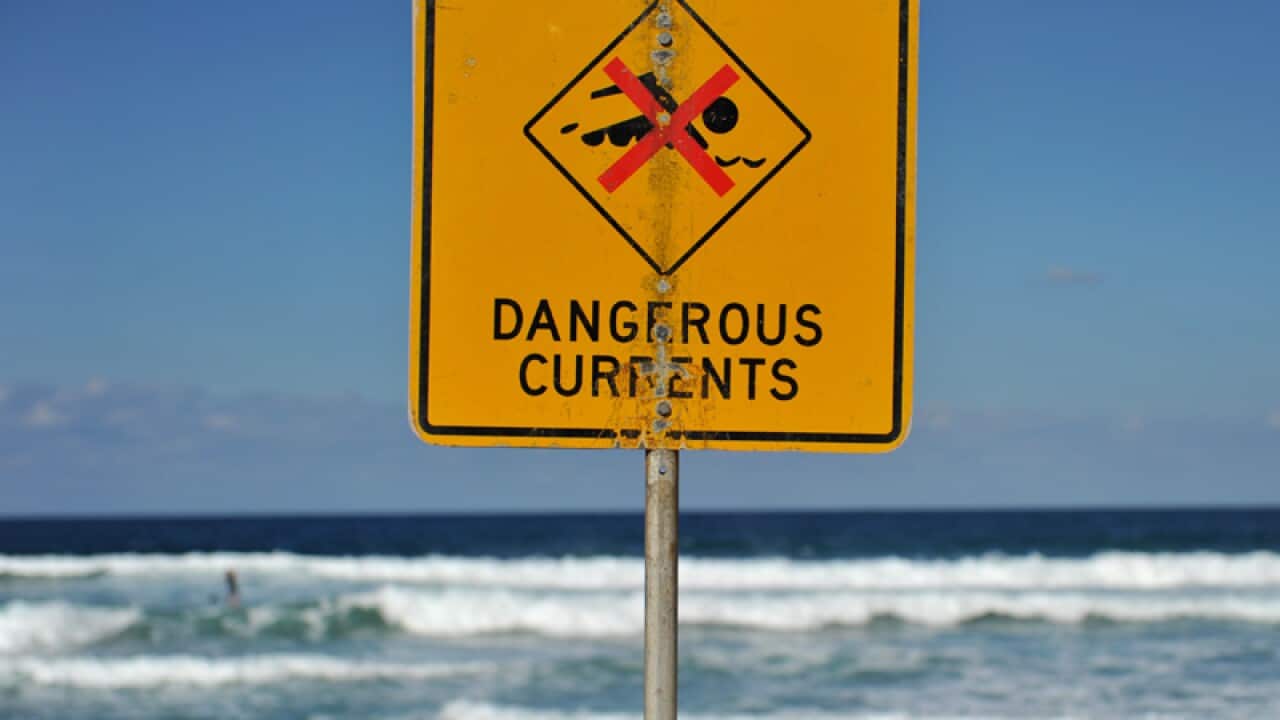 A sign warning of dangerous currents alerts