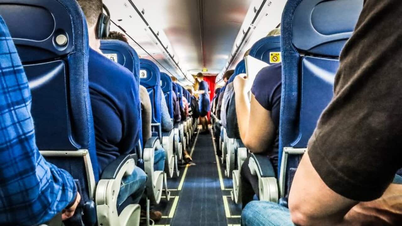 Rear View Of People Sitting In Airplane