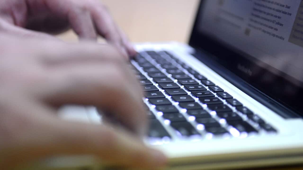 A man uses a laptop computer.
