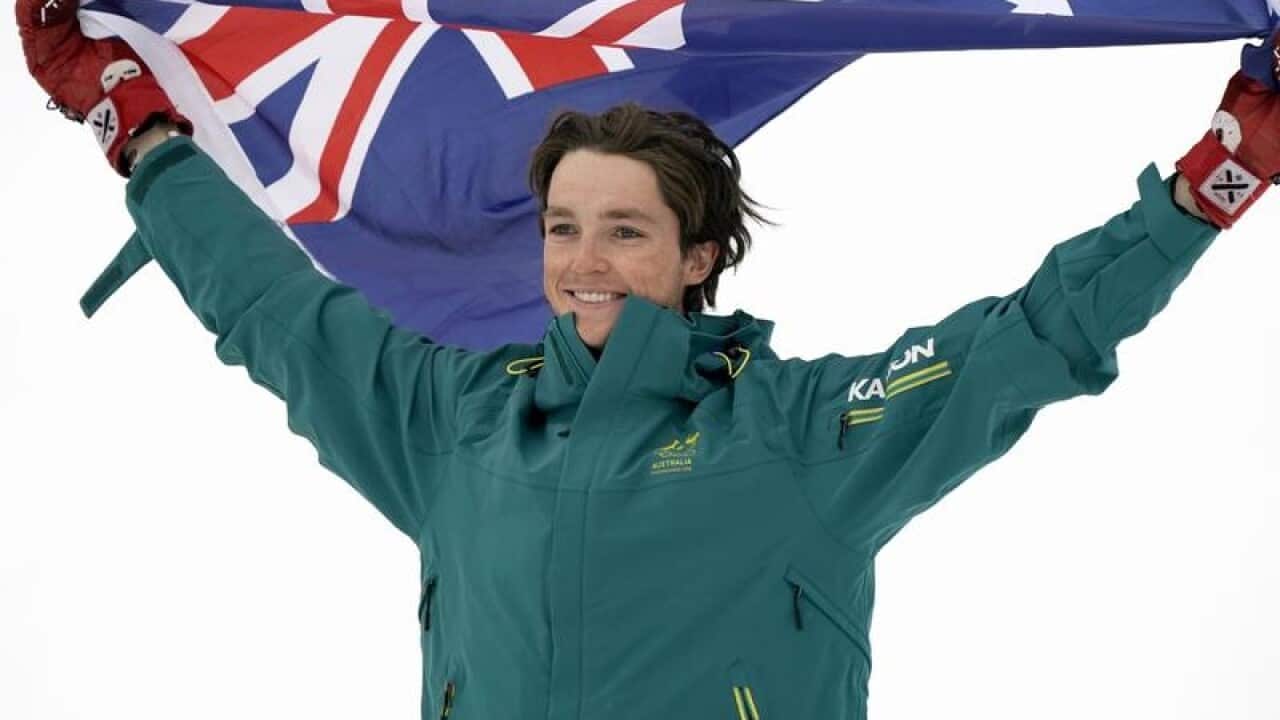Bronze medal winner Scotty James holds the Australian flag.