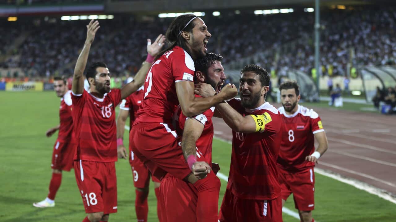 Syria's soccer team celebrates after scoring a goal against Iran during their Round 3 - Group A World Cup qualifier at the Azadi Stadium in Tehran, Iran, Tuesday, Sept. 5, 2017. The match draw 2-2. (AP Photo/Vahid Salemi)