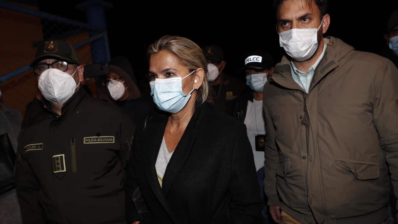 Bolivia's former Interim President Jeanine Anez, center, who has been detained, is escorted by Government Minister Carlos Eduardo Del Castillo, right, and Bolivian Police Commander Jhonny Aguilera.