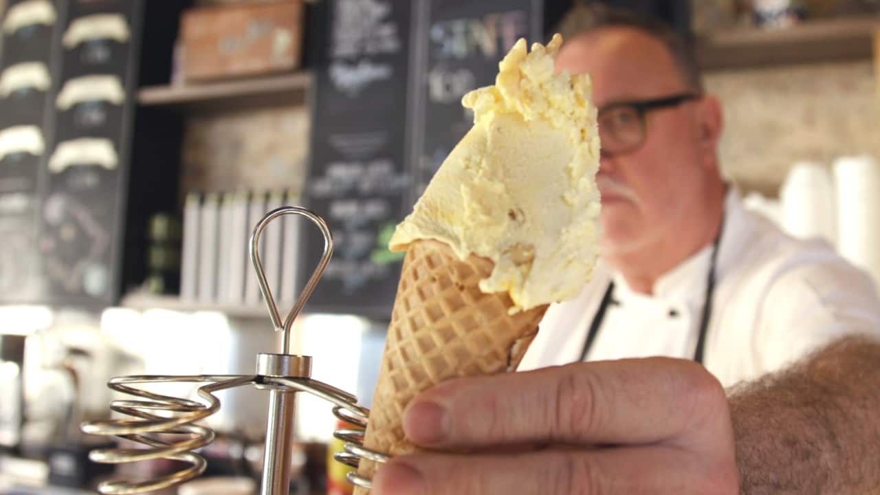 Ice cream being handed to customer at Cow & the Moon