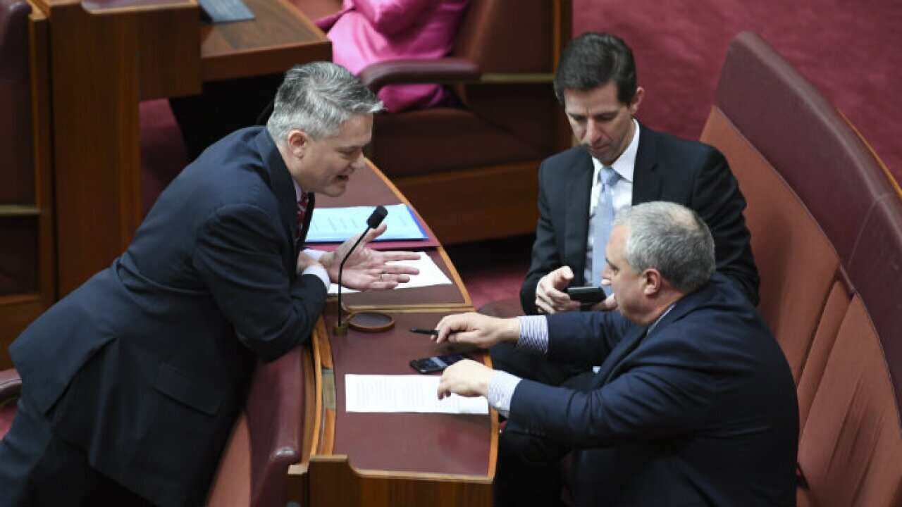 finance minister Mathias talking with others in senate