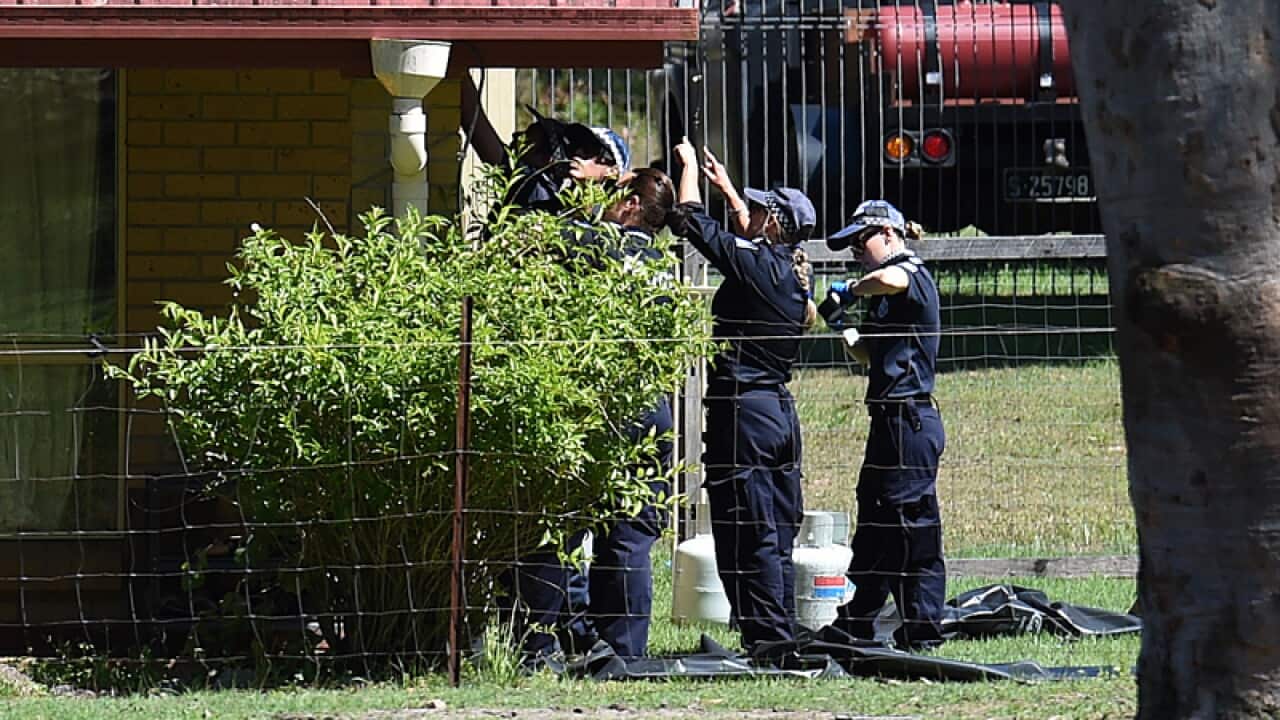 Police officers examine a property connected to Tiahleigh Palmer