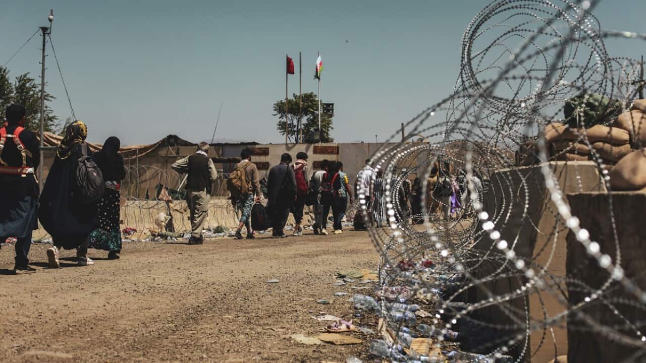 Evacuees wait to be processed at Hamid Karzai International Airport on 25 August 2021.