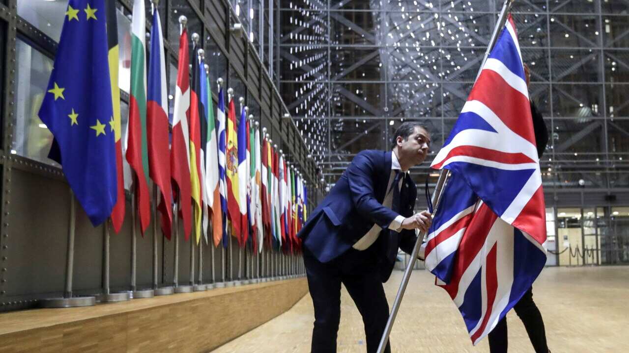 The Union flag is removed from the atrium of the Europa building in Brussels as the UK officially leaves the EU.