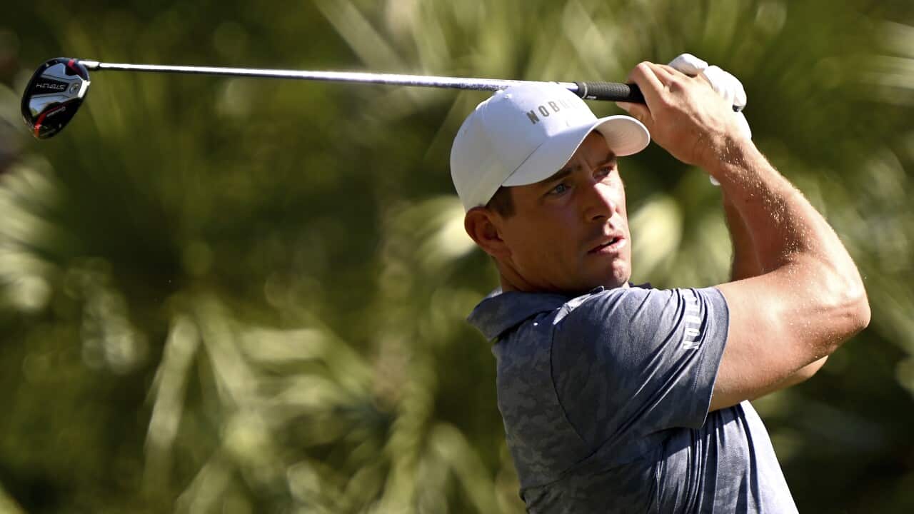 A golfer taking a drive