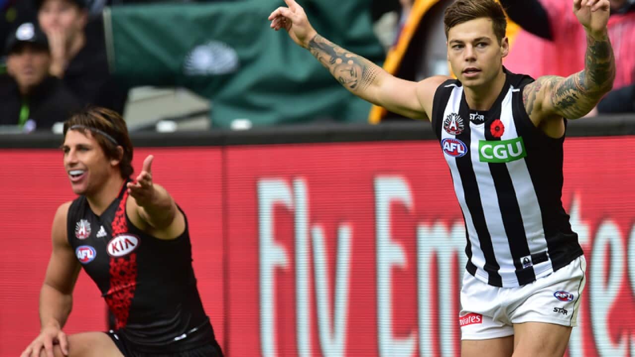 Magpies player Jamie Elliot (R) after scoring goal against the Bombers
