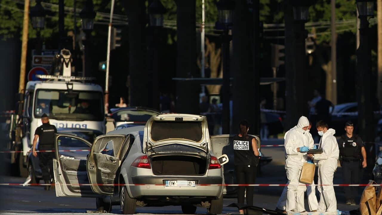 Police attend the scene on Champs Elysees avenue in Paris.