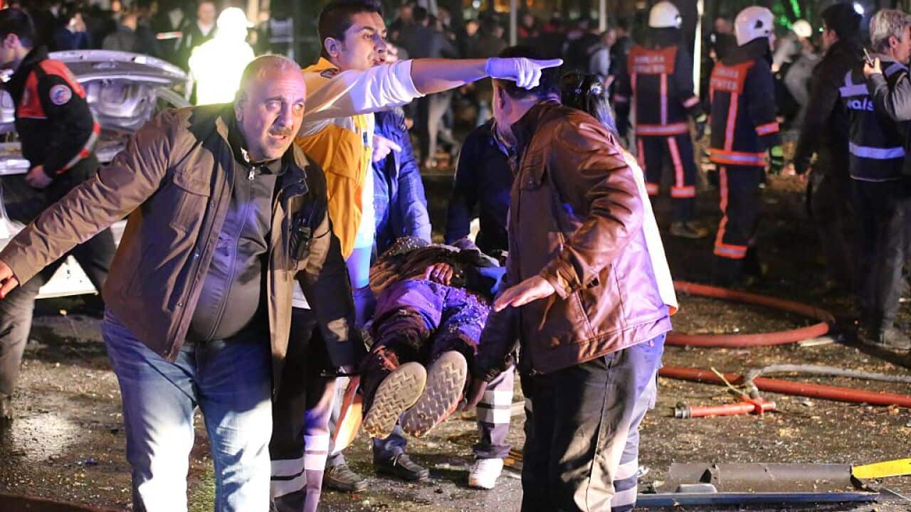 Rescuers carry a victim on a stretcher at the scene of a blast in Ankara on March 13, 2016.