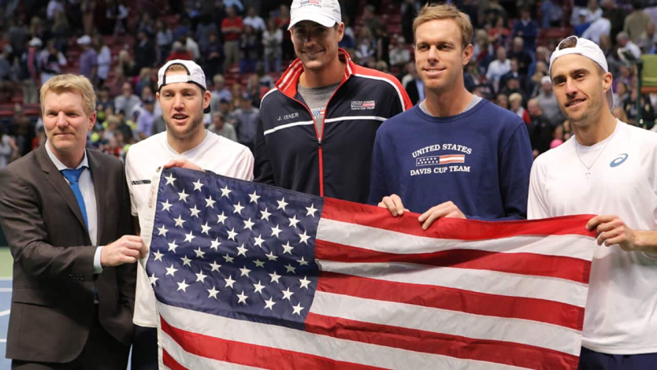 Team USA pose with an American flag