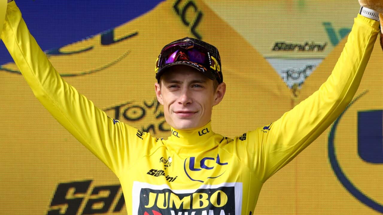 Jonas Vingegaard (Jumbo-Visma) celebrates in the yellow jersey ahead of the final stage to Paris.jpg