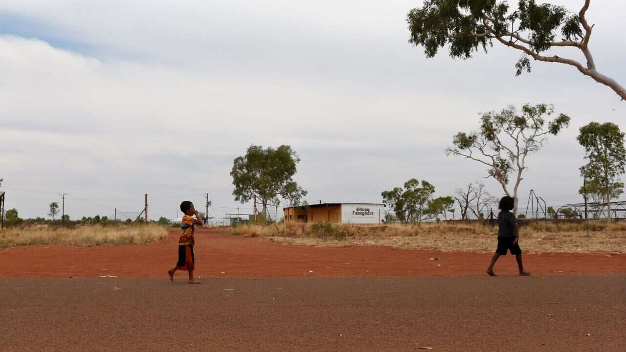 Children walk along a road