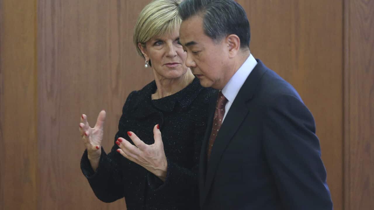 Chinese Foreign Minister Wang Yi and Australian Foreign Minister Julie Bishop talk after a joint press conference at the Ministry of Foreign Affairs in Beijing, China, 17 February 2016. (AAP)