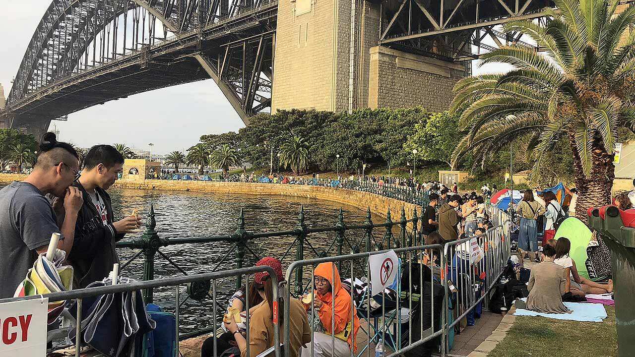 New Year's Eve revellers gather along the foreshore in Sydney ahead of the fireworks.