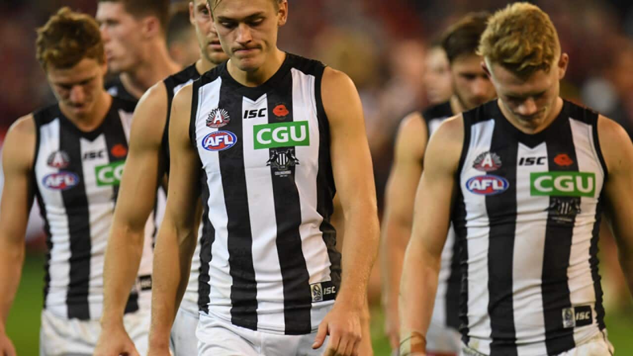 Darcy Moore (left) and Adam Treloar of the Magpies