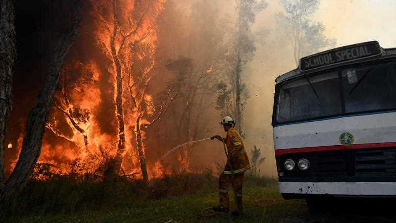 Rural Fire crews battle a bush fire burning near houses along Lemon Tree Passage Road, in Salt Ash, earlier this year.