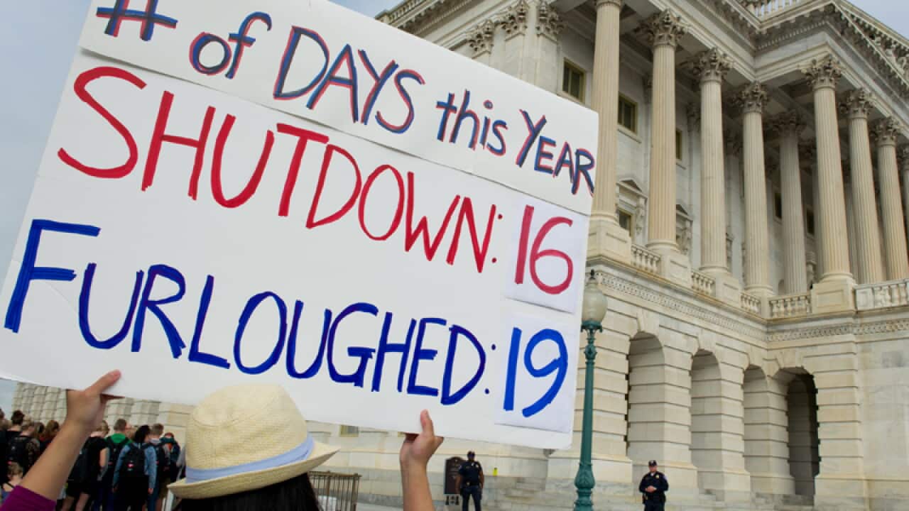 A government employee protests at the US Capitol on Wednesday