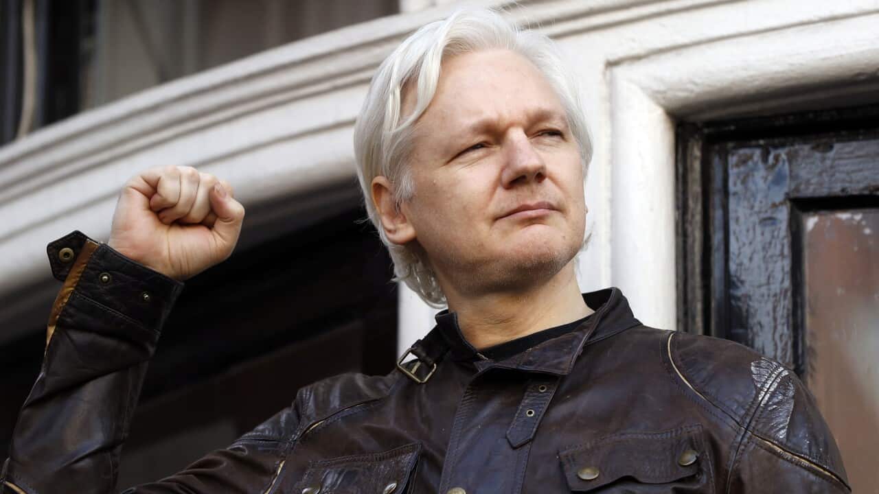 WikiLeaks founder Julian Assange greets supporters outside the Ecuadorian embassy in London.