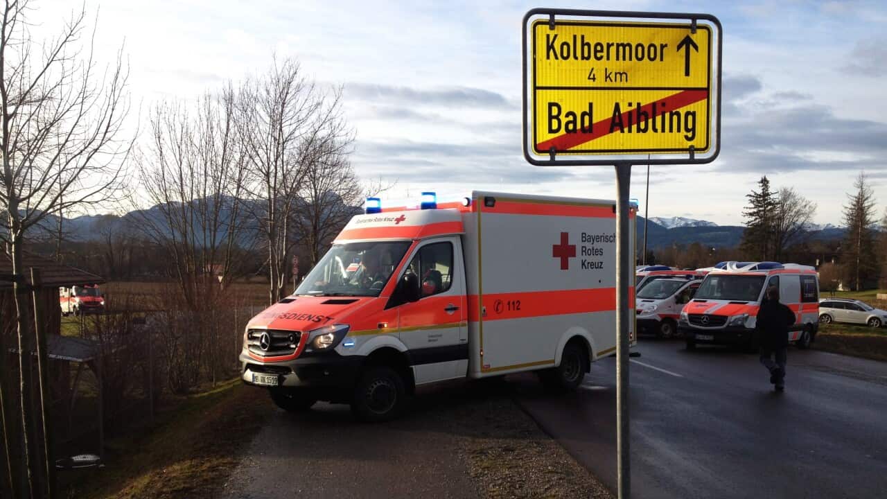 An ambulance next to an exit sign for Bad Aibling, Bavaria, near a train collision in Germany.