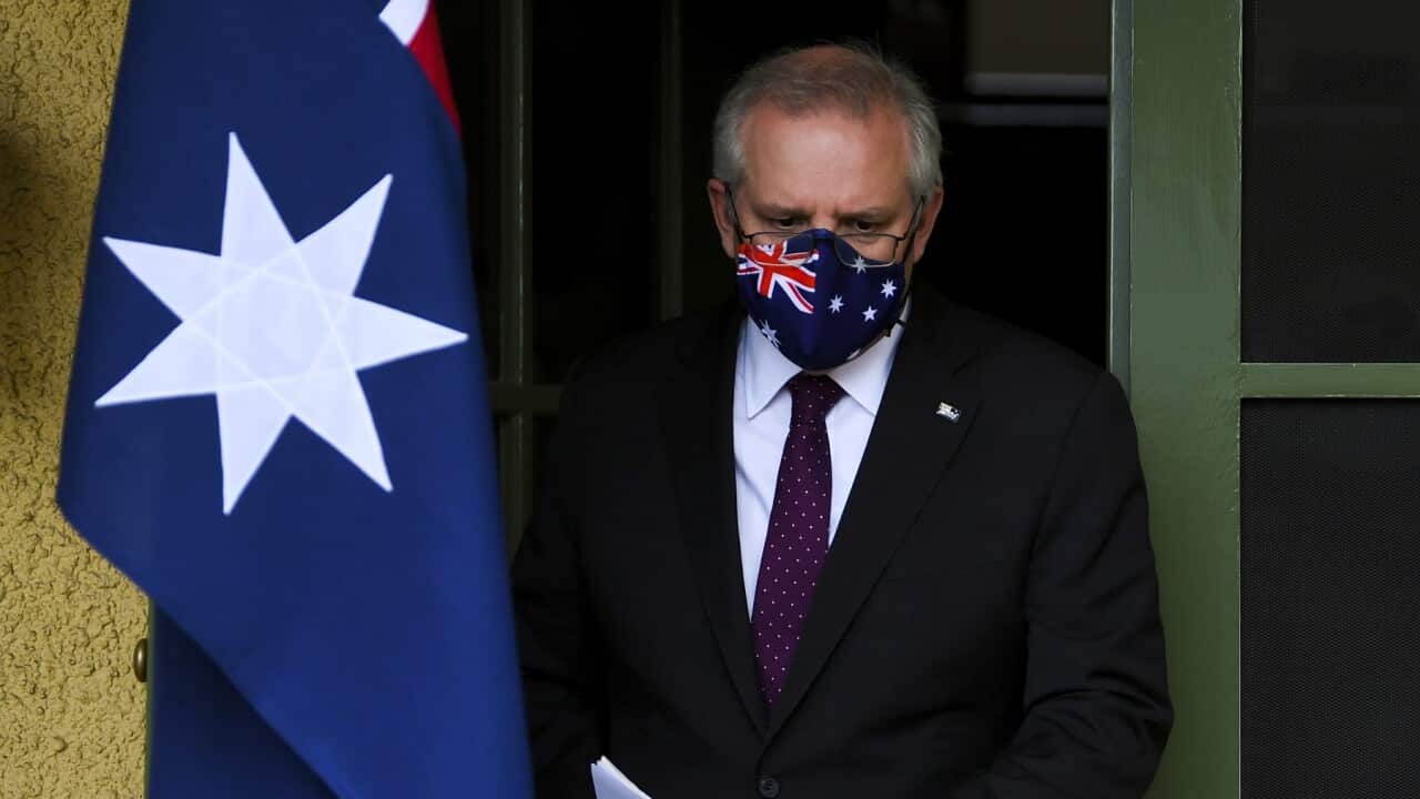 Australian Prime Minister Scott Morrison arrives to speak to the media during a press conference at the Lodge in Canberra, Sunday, July 25, 2021. (AAP Image/Lukas Coch) NO ARCHIVING