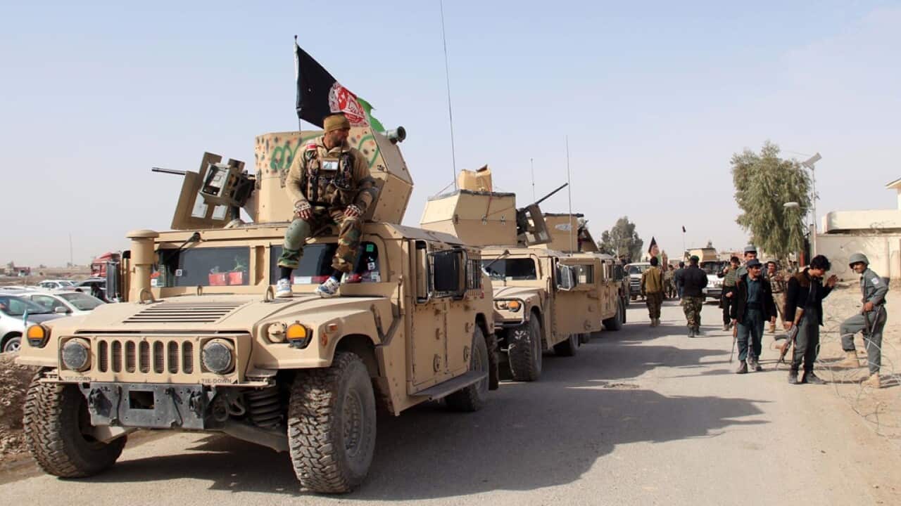 Afghan security officials patrol