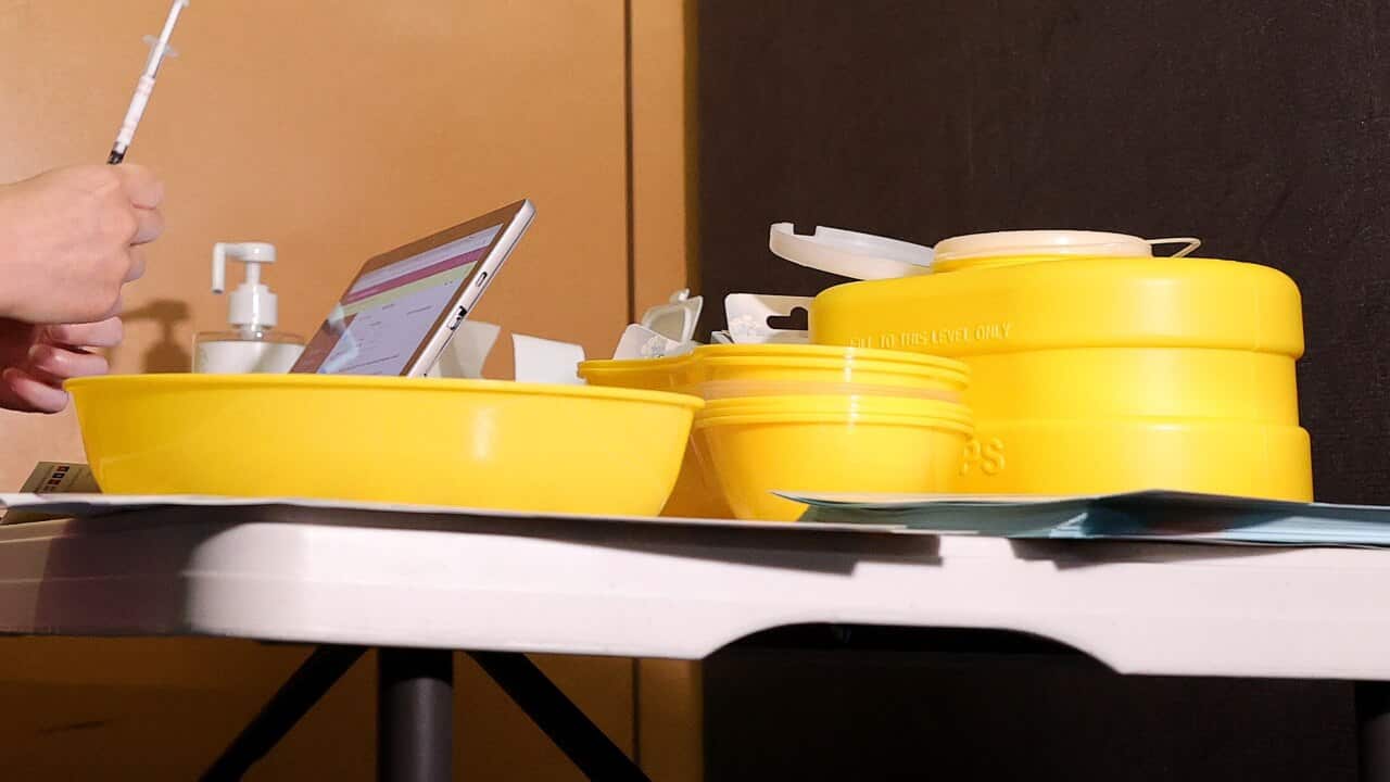 A health worker is seen at a pop-up vaccination clinic