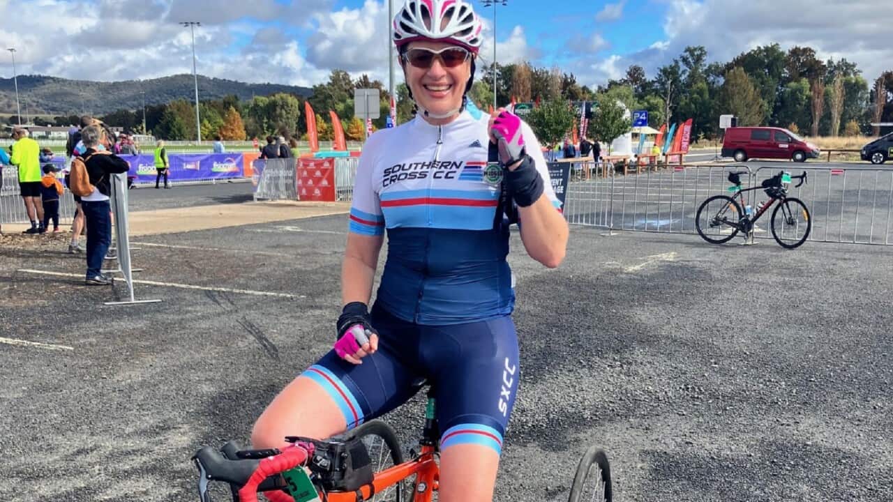 Gabrielle Vassallo smiling in bike gear on her modified bike.