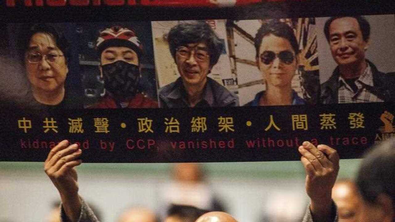 A poster that reads 'Missing: Impossible' with the photos of 5 missing booksellers hangs on the entrance to Causeway Bay Books store in Hong Kong, China