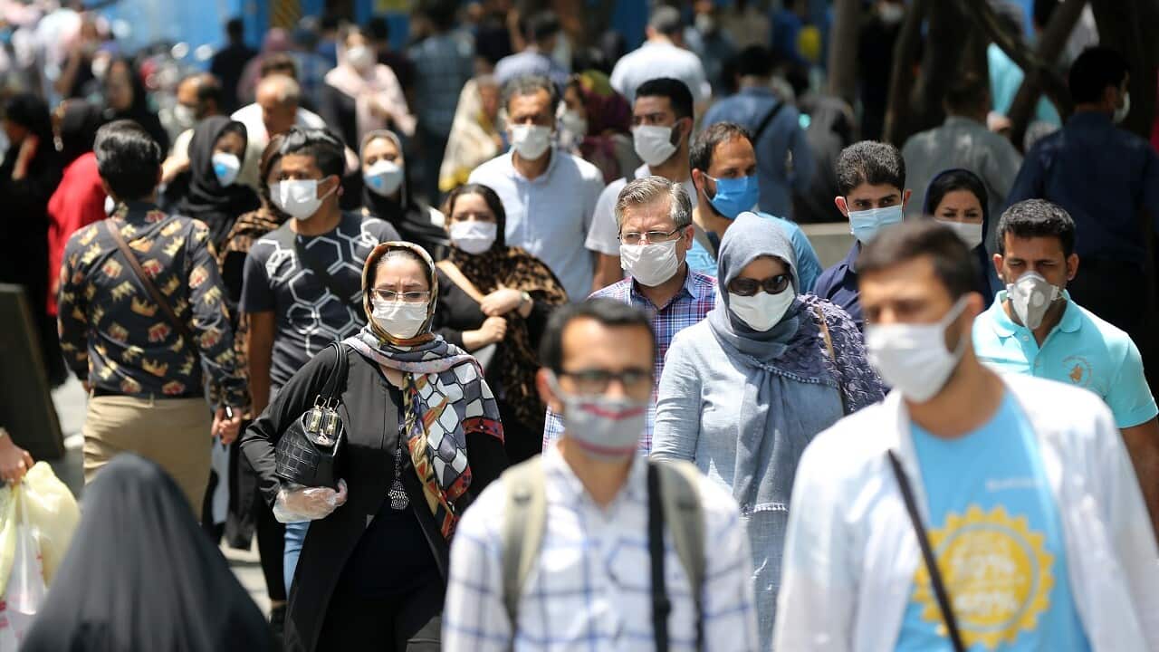 People wear protective masks in Tehran, Iran.