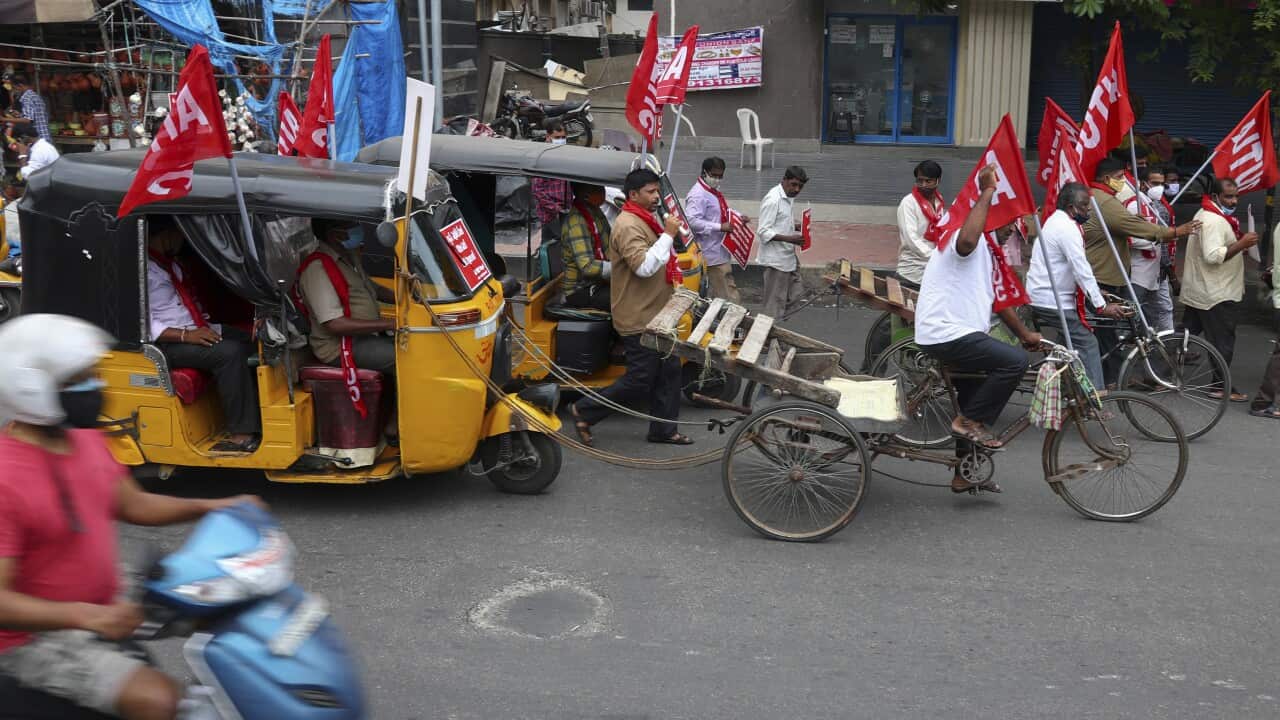 Auto rickshaw owners associated with All India Trade Union Congress (AITUC) pull their vehicles using cycle rickshaws to protest against the hike of petrol and diesel prices in Hyderabad, India, Saturday, July 10, 2021. (AP Photo/Mahesh Kumar A.)
